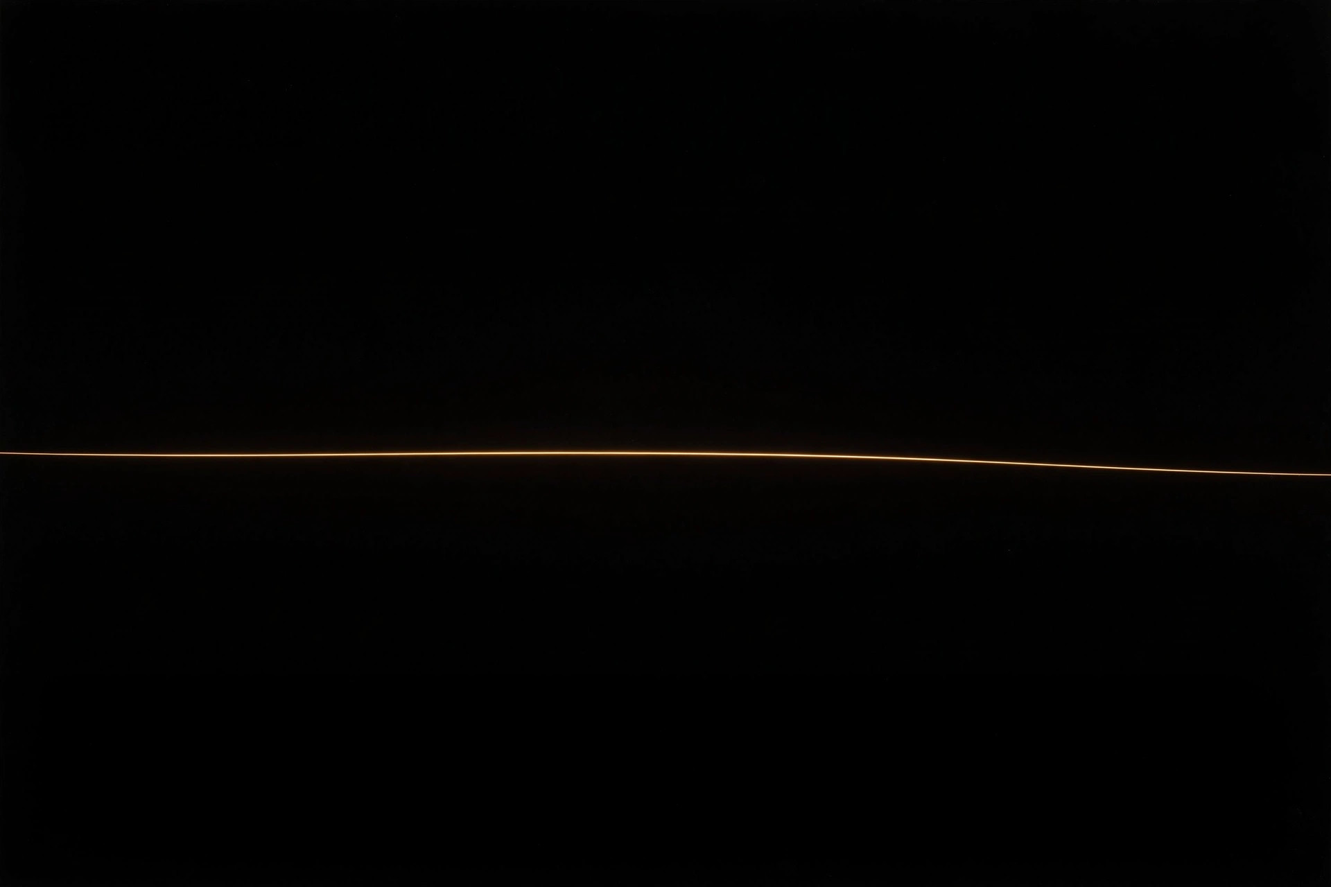 Single thin gold line of light across a black void